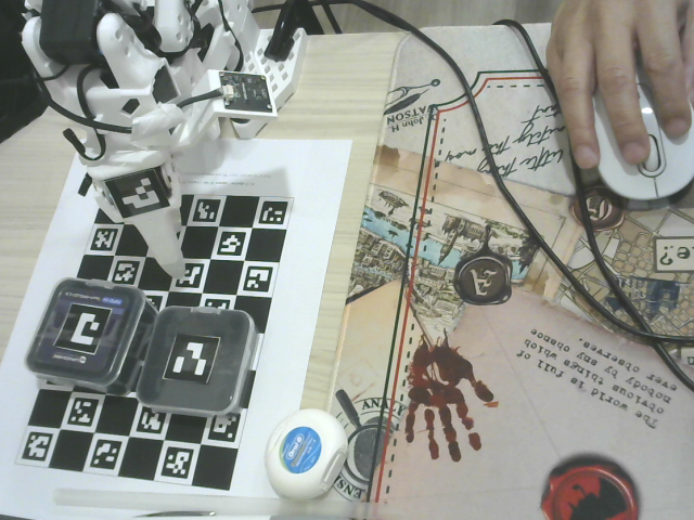 Wide view of the SO-ARM101 follower, ChArUco board, marker-tagged objects and operator zone